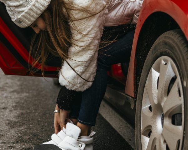 woman-getting-her-skateboard-out-car